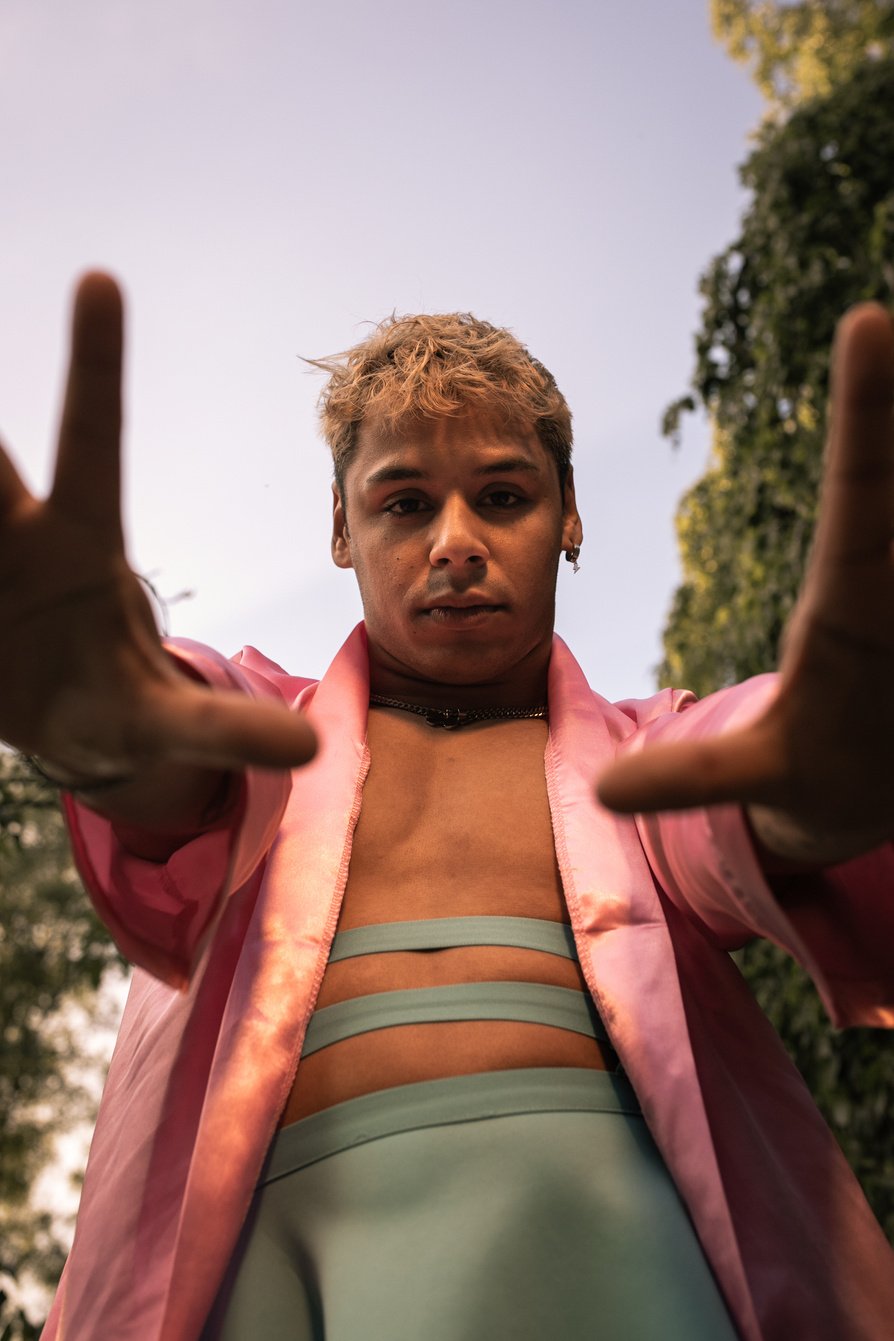 Man in Pink Robe and Green Skirt Outdoors