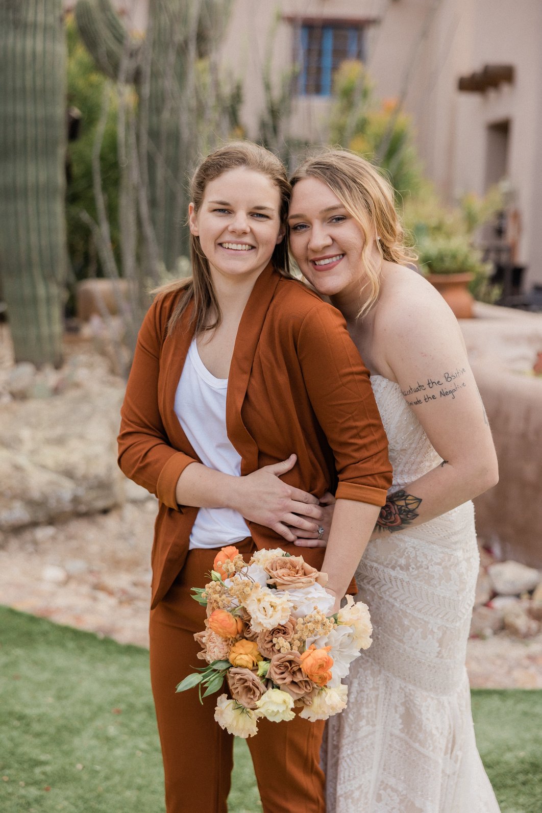 Newlywed Couple with Bridal Bouquets Posing Outdoors